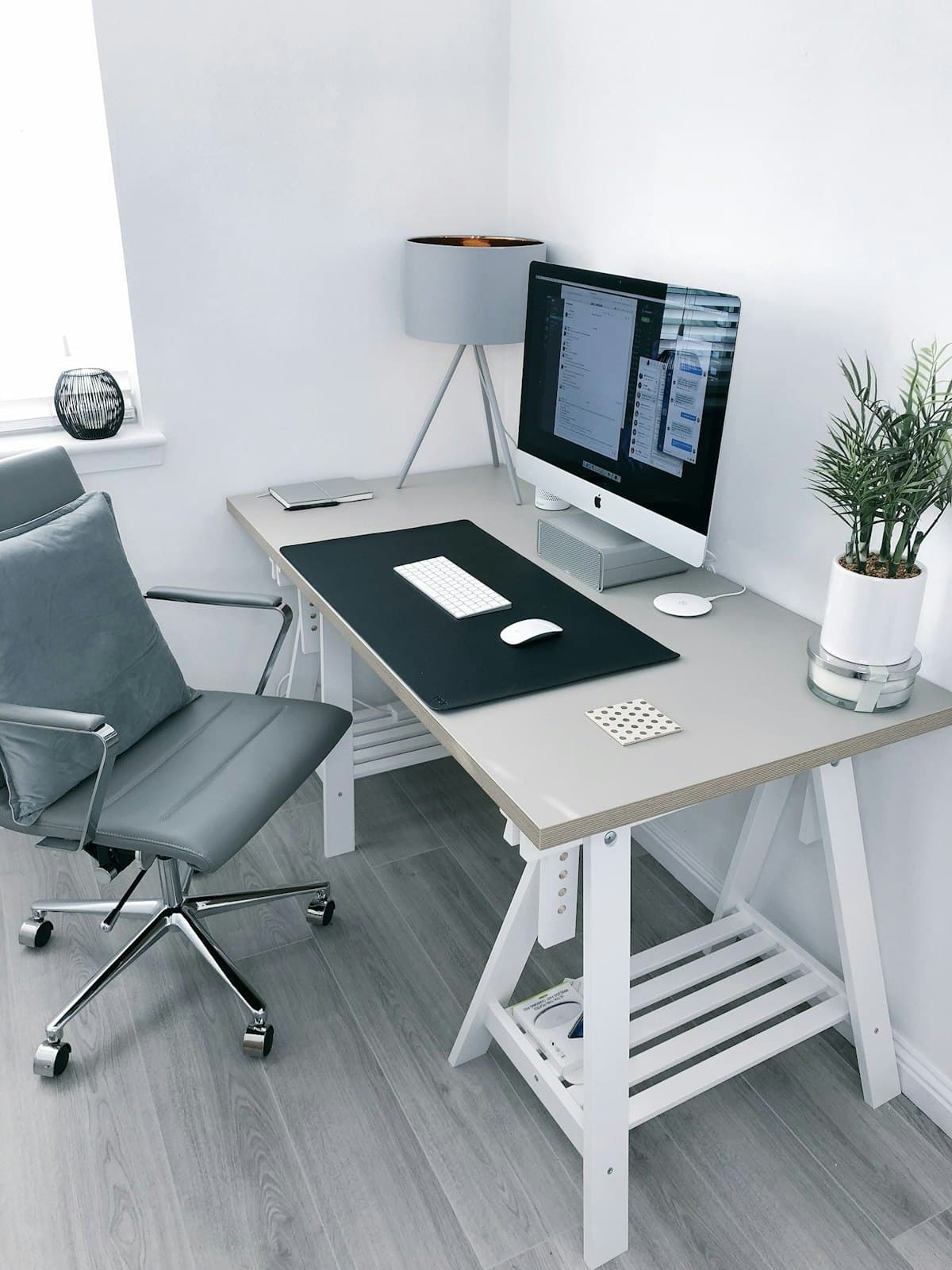 A tidy office workspace with a desk, computer, and office chair