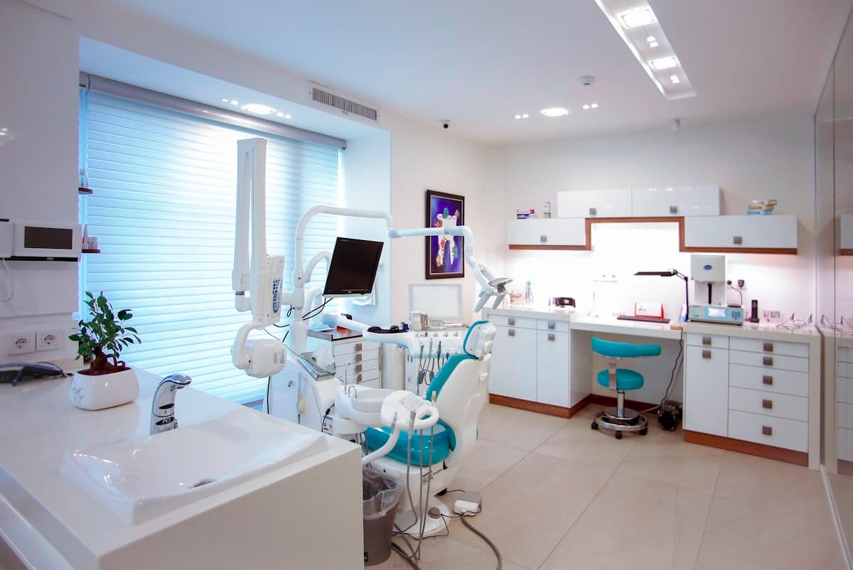 An empty dental operatory with the chair, stool and wall monitor unoccupied
