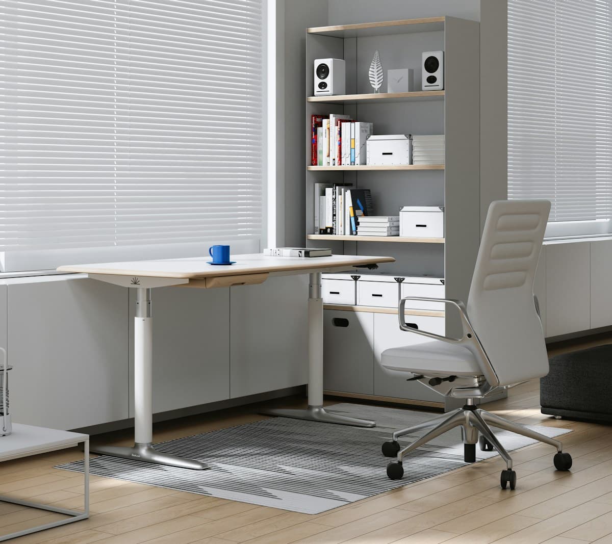 A bright, tidy modern office with a desk and shelves
