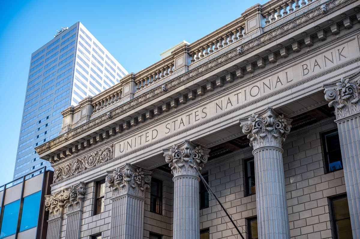 The carved stone facade of a grand old bank building